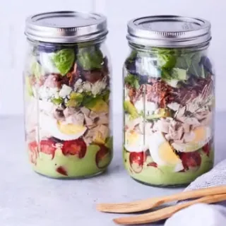 Cobb salad layered in two glass jars